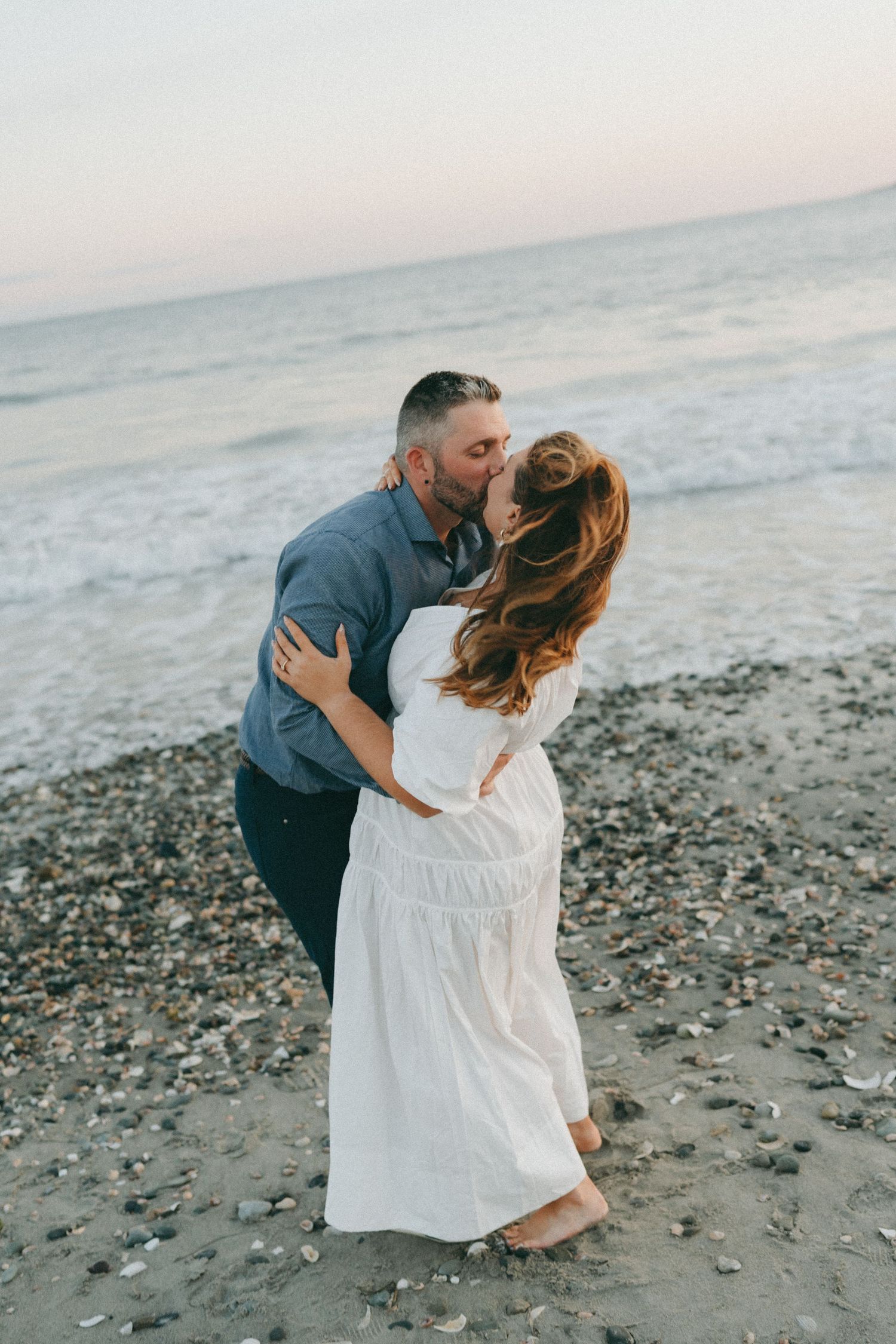 A romantic beach embrace captured during golden hour.