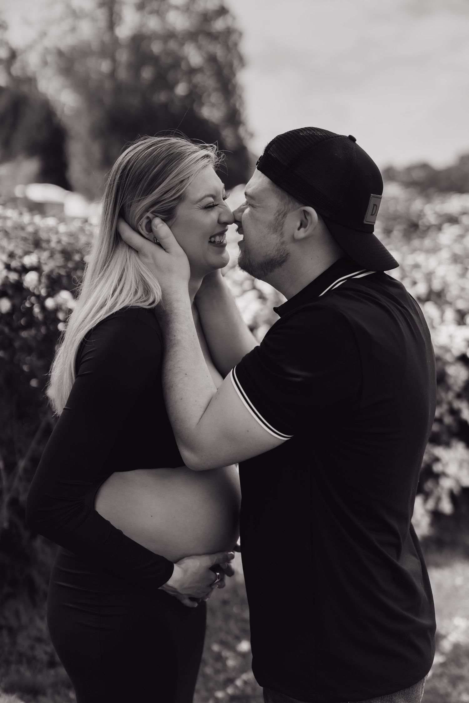 Black and white photo series of a couple sharing intimate moments outdoors.