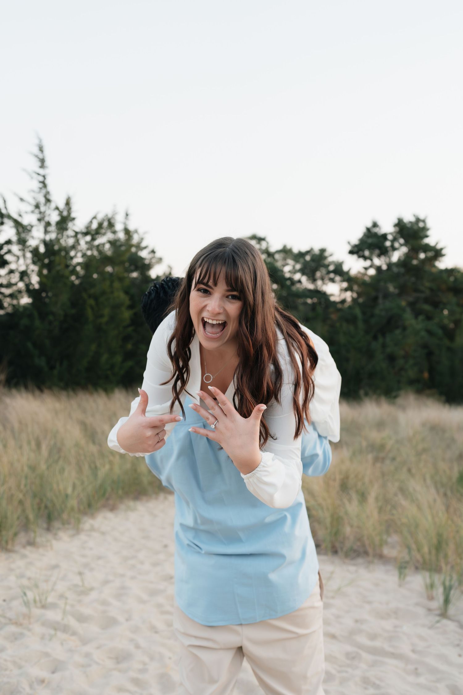 An excited reaction captured during a beach proposal moment.