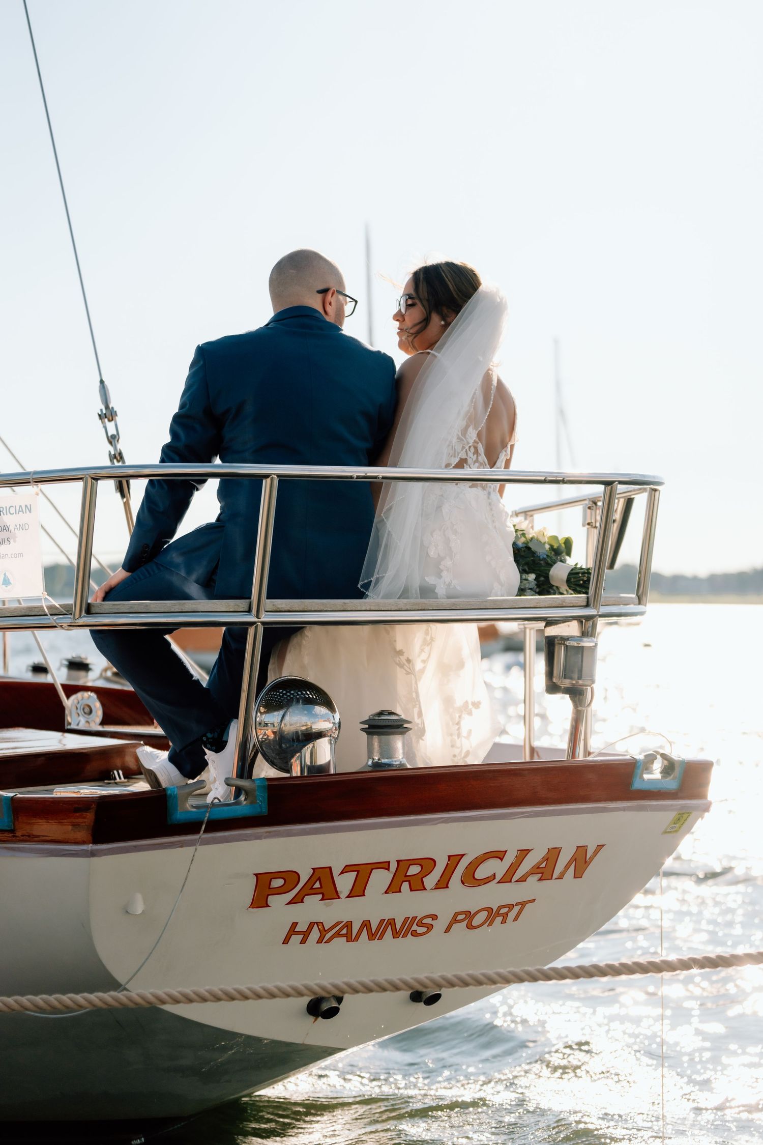 A couple sits on the stern of a boat named Patrician from Hyannis Port.