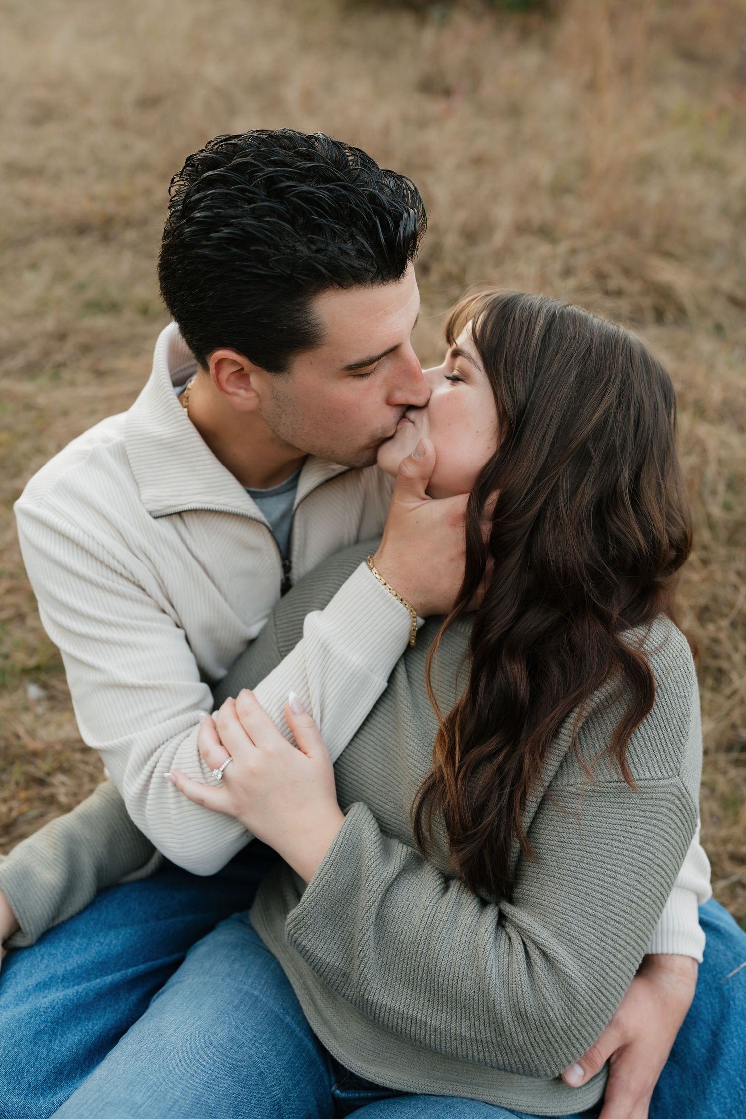 A tender embrace captured in a rustic outdoor setting during golden hour.