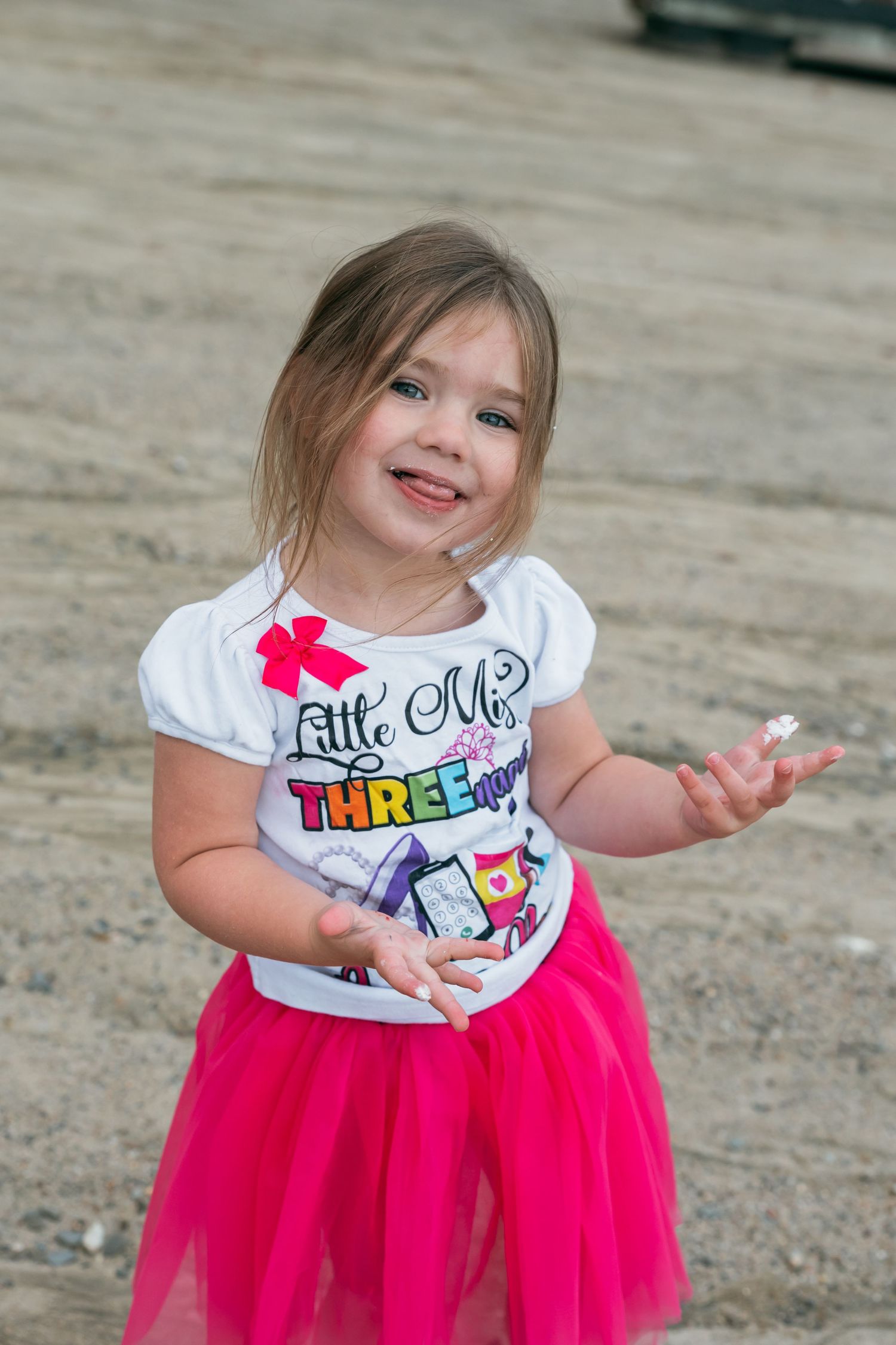 Young child in pink tutu and birthday shirt twirling and dancing.