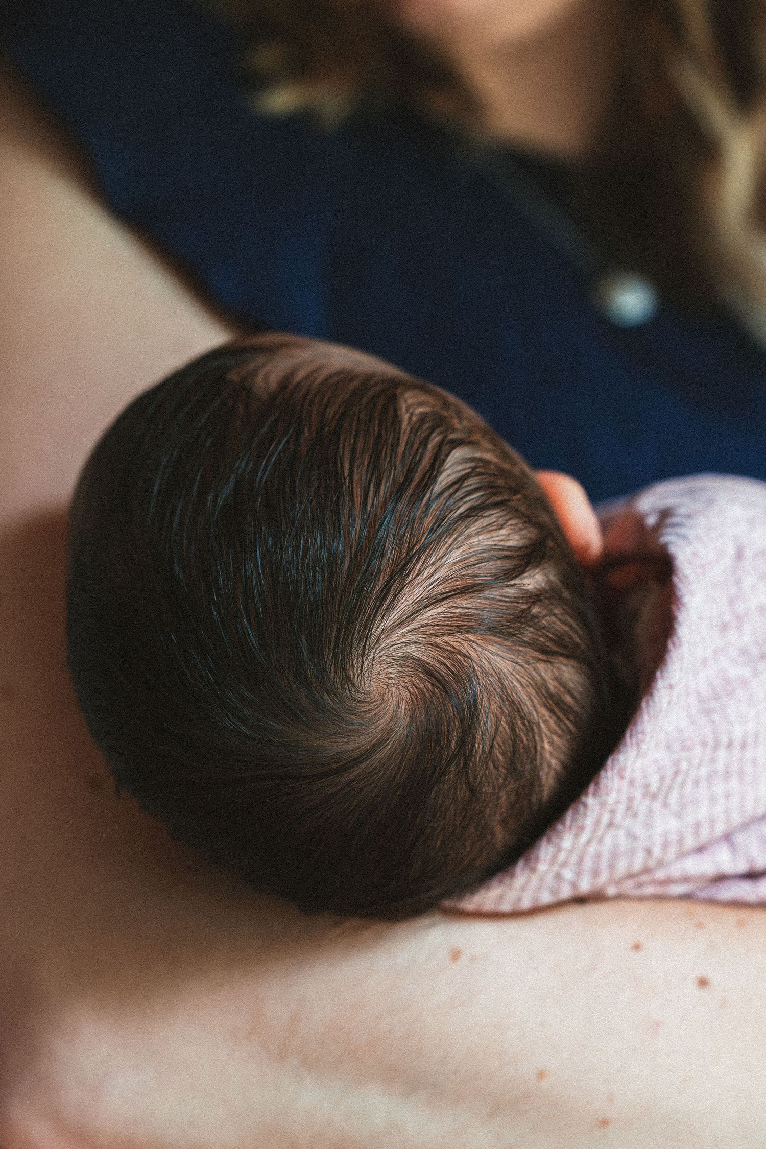 Close-up series showing a baby's dark hair while sleeping.