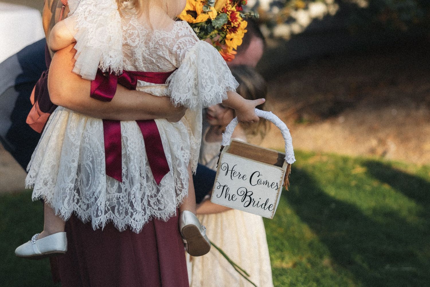 Wedding detail shot showing lace and burgundy accents.
