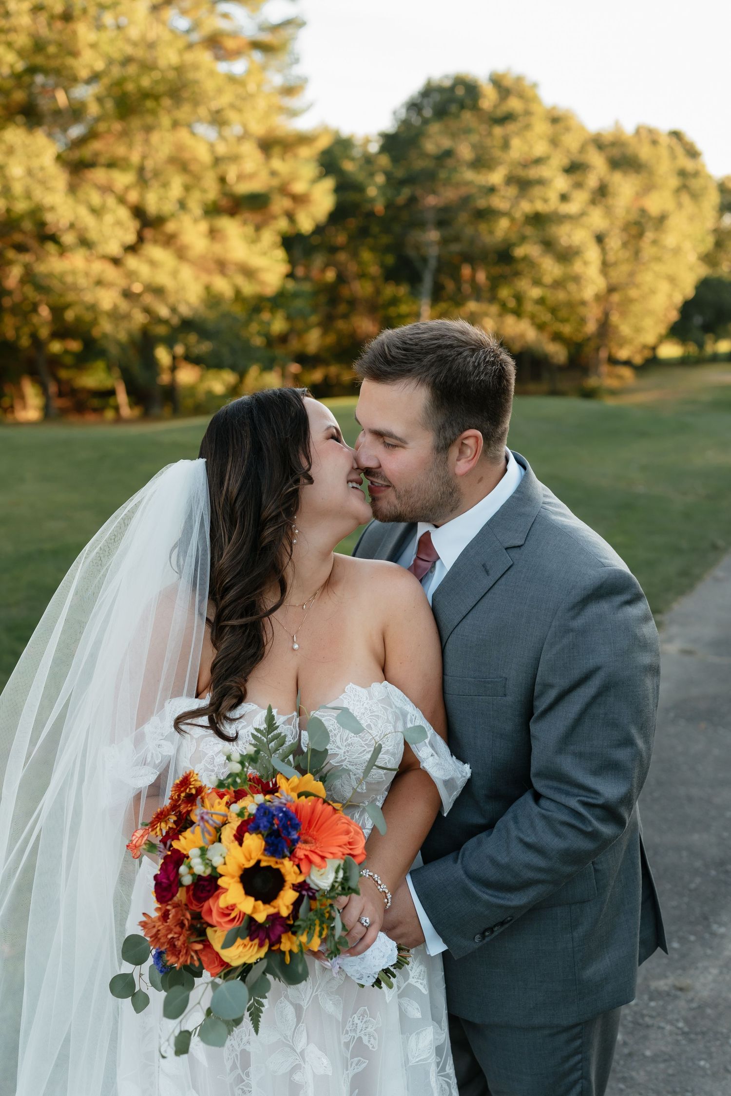 Intimate wedding portraits captured at sunset with fall-colored florals.