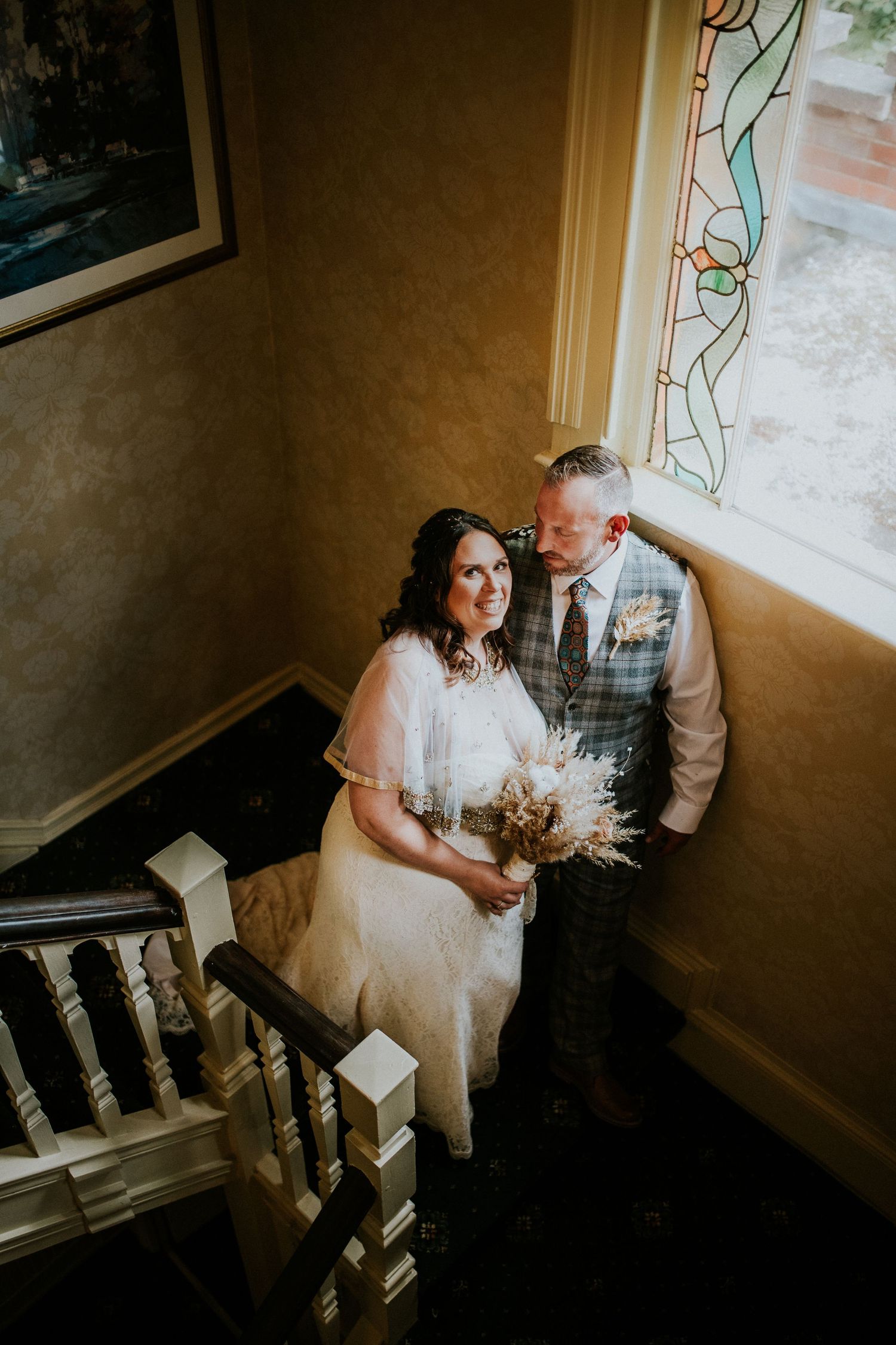 Intimate wedding photography session on vintage staircase with natural lighting.