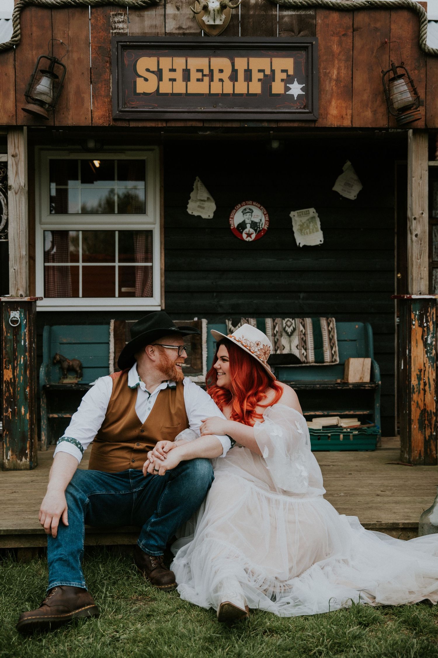Western-themed setting with sheriff sign and rustic wooden porch elements.
