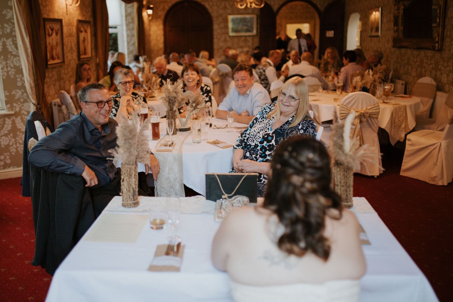 Wedding reception banquet hall with arched architecture and elegant table settings.