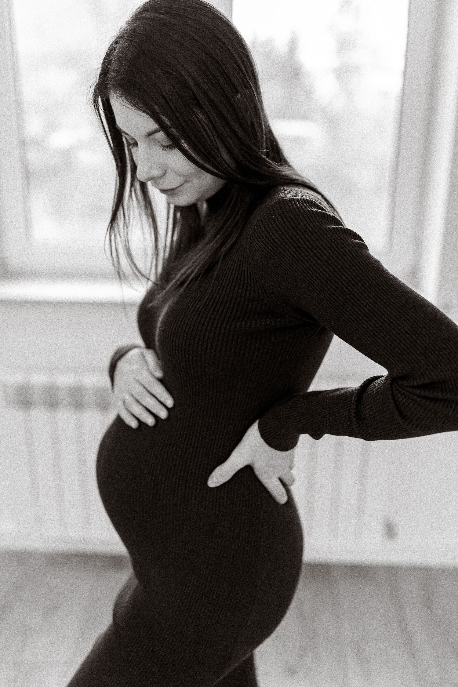 Series of black and white portraits showing pregnancy silhouette in ribbed sweater.