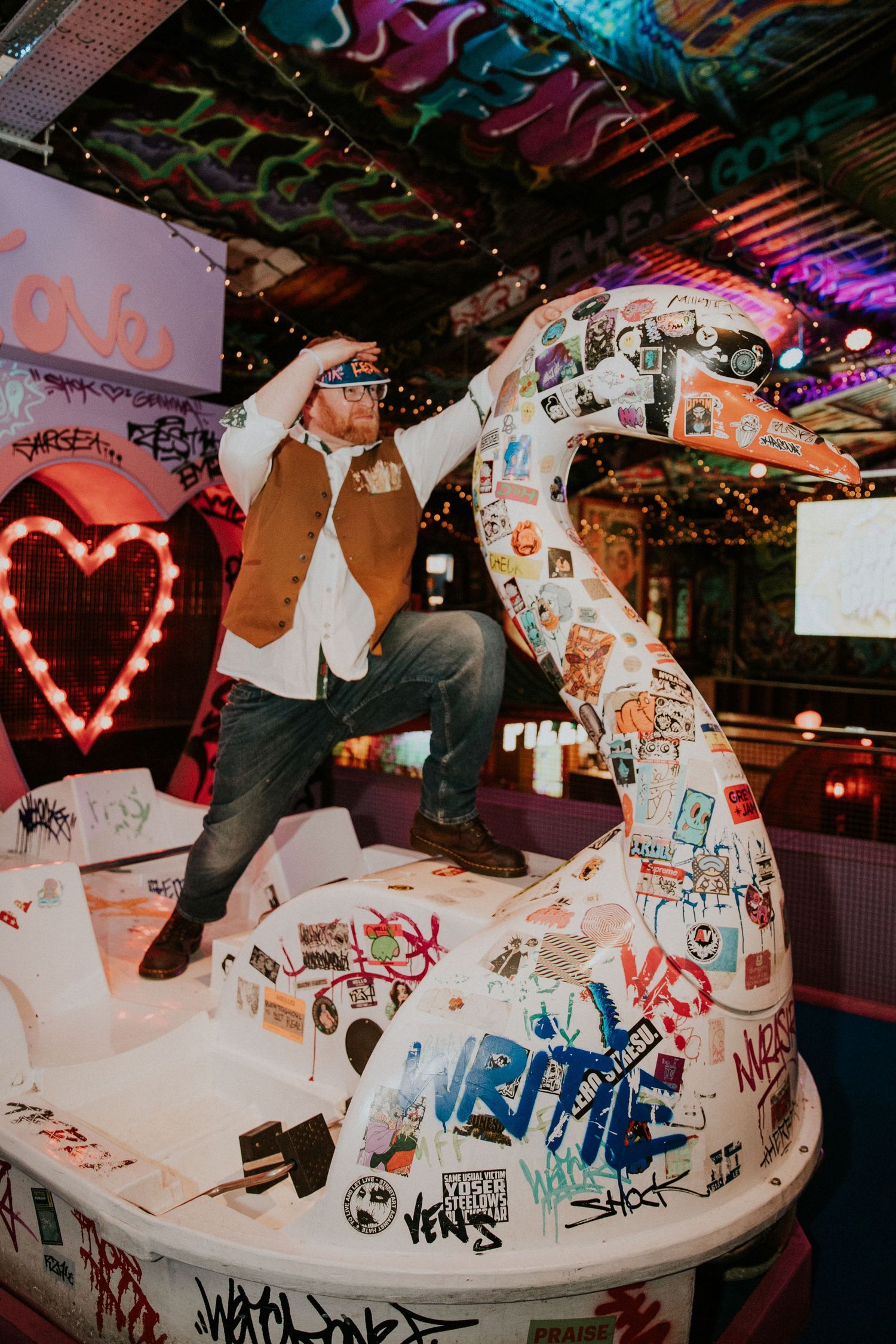 Graffiti-covered white car serving as unique wedding photo backdrop.