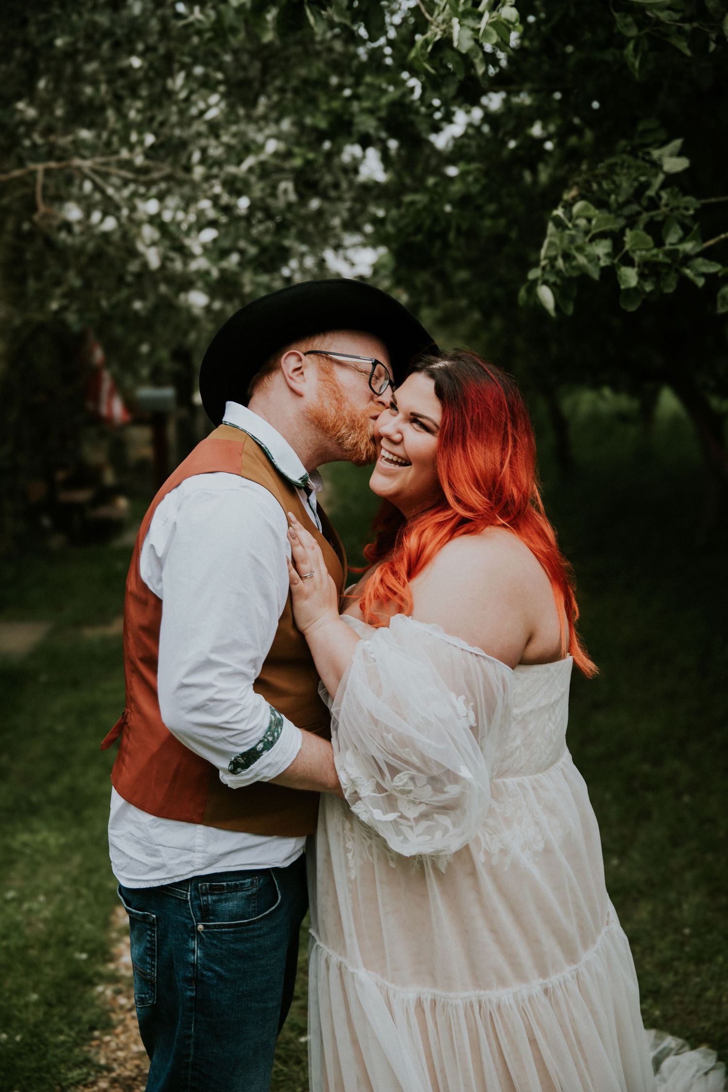 Intimate outdoor portrait session in a lush green garden setting.