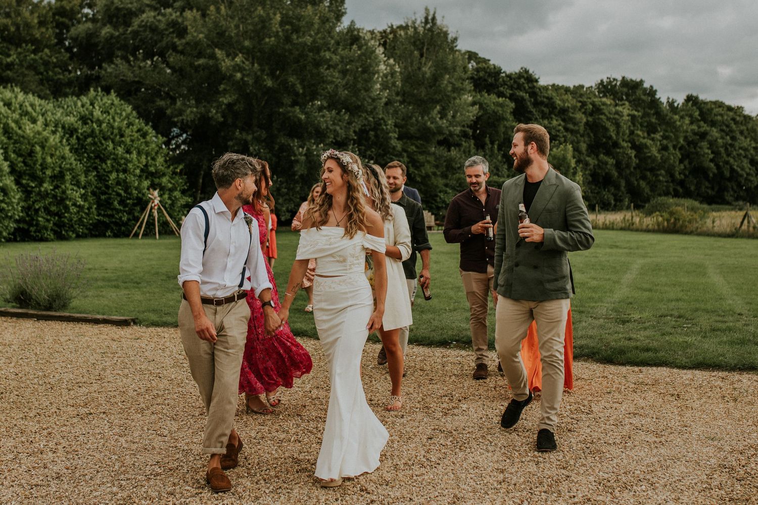 Wedding ceremony setup with gravel path leading to outdoor seating area.