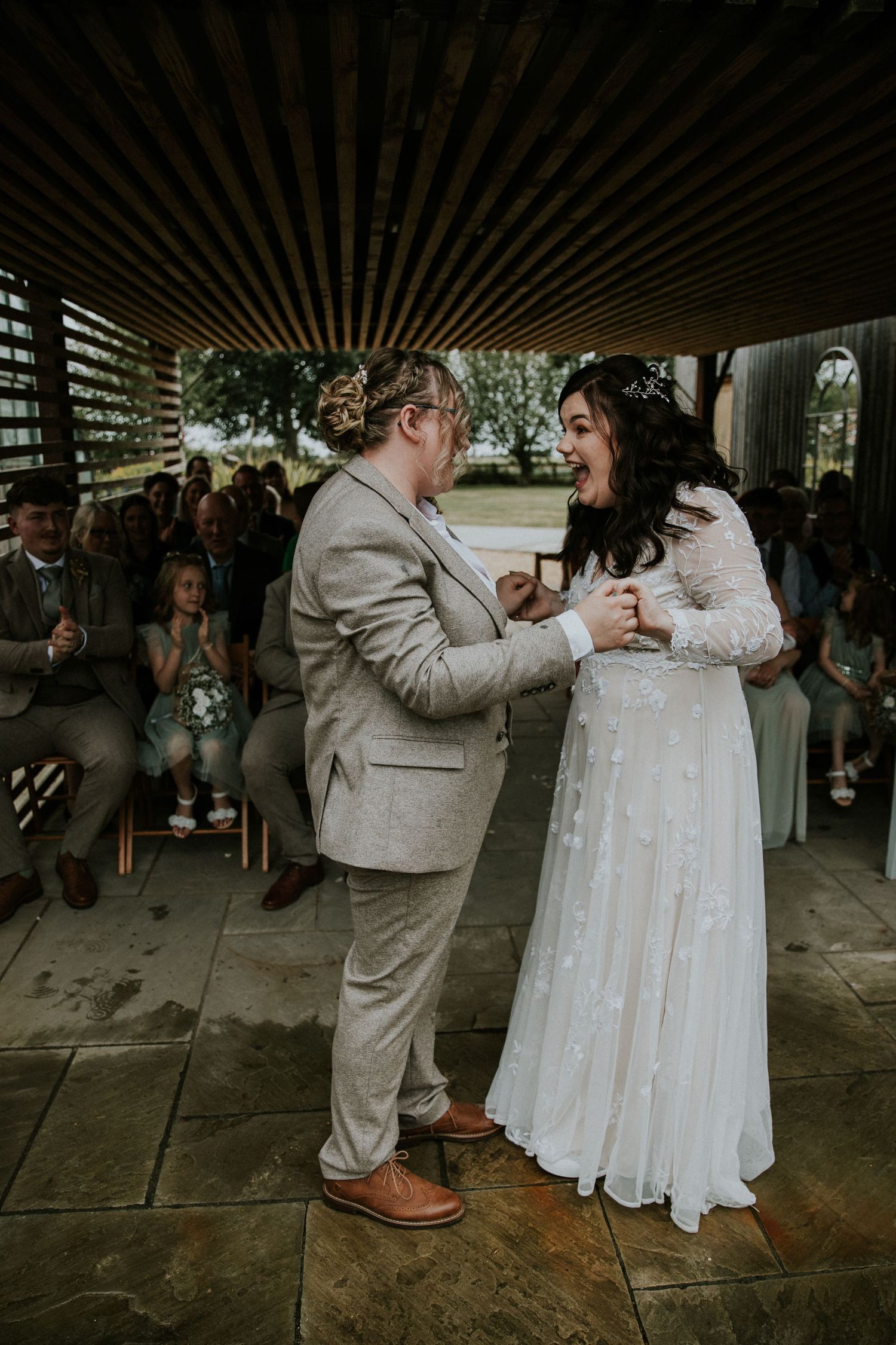 Wedding couple sharing an intimate dance moment under a covered outdoor venue.