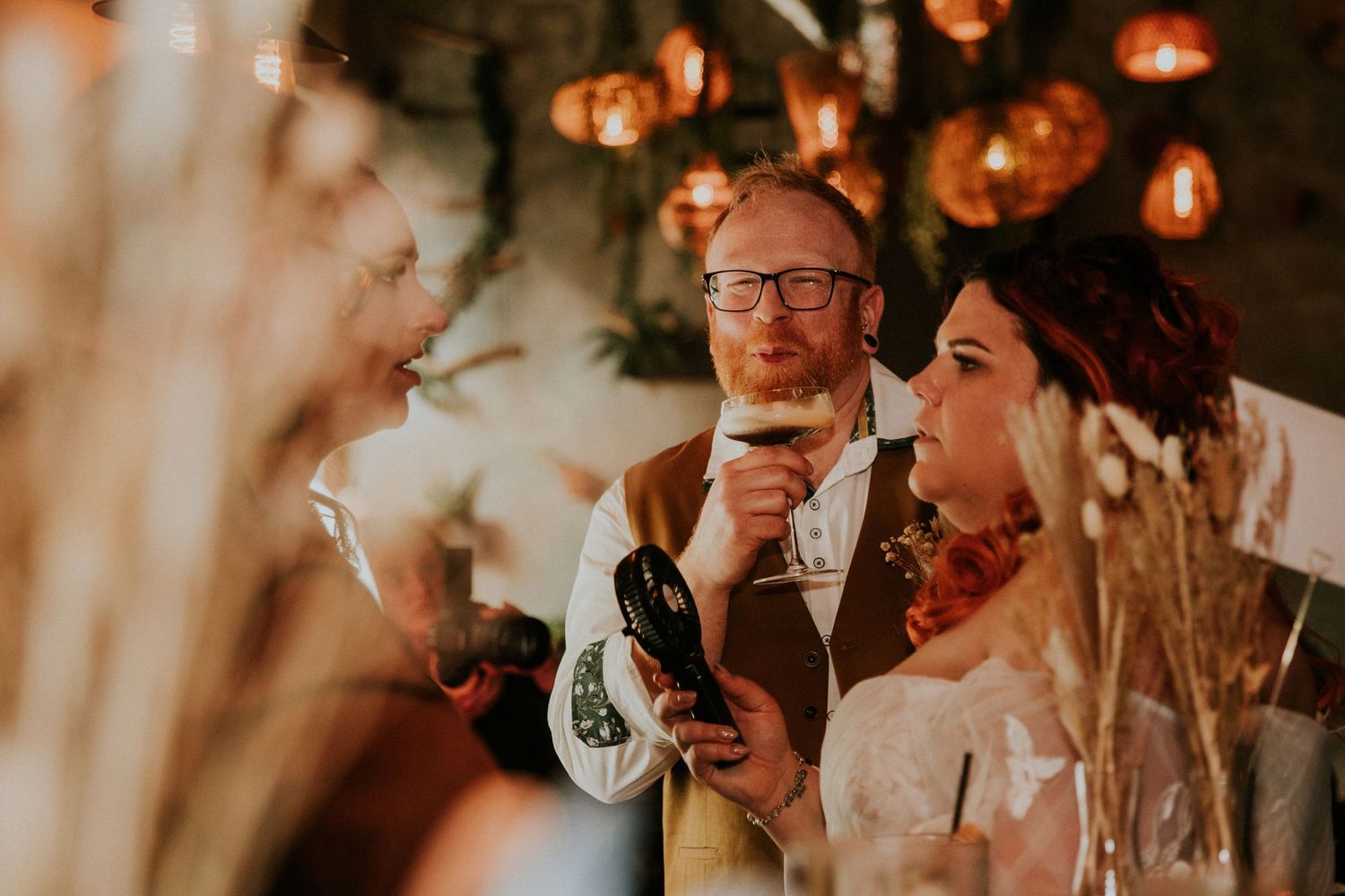 Warm ambient lighting creates romantic atmosphere at an indoor wedding reception.