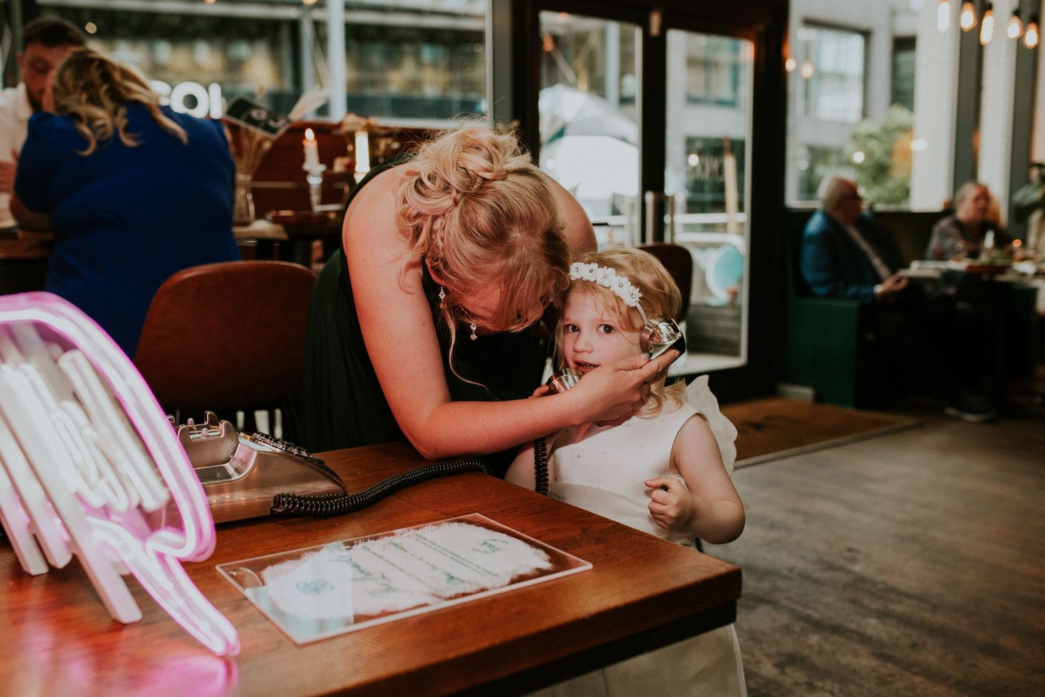 Wedding guests enjoying table conversation at an intimate restaurant reception.