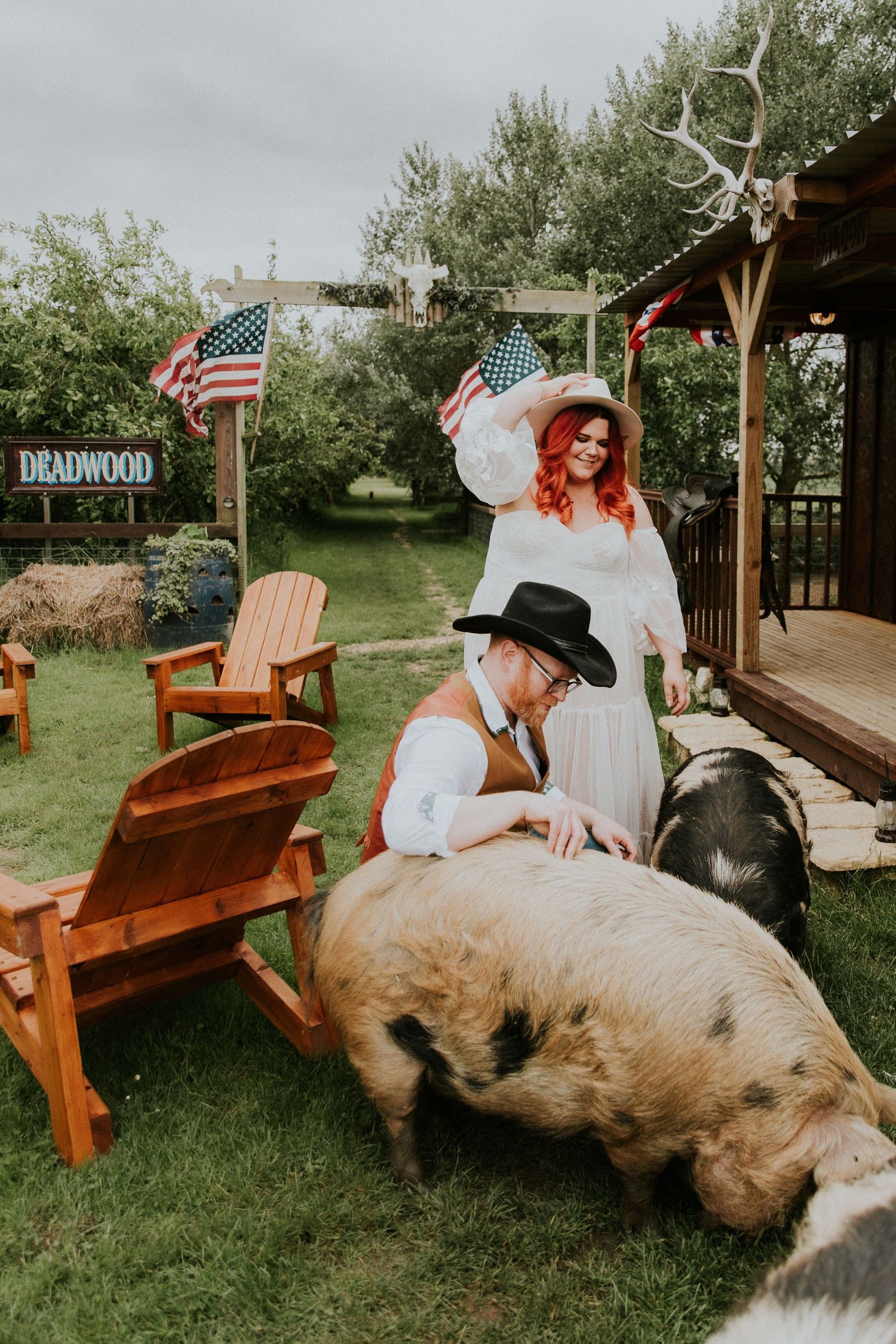 White bench on a rustic porch decorated with American flags and country-western decor.