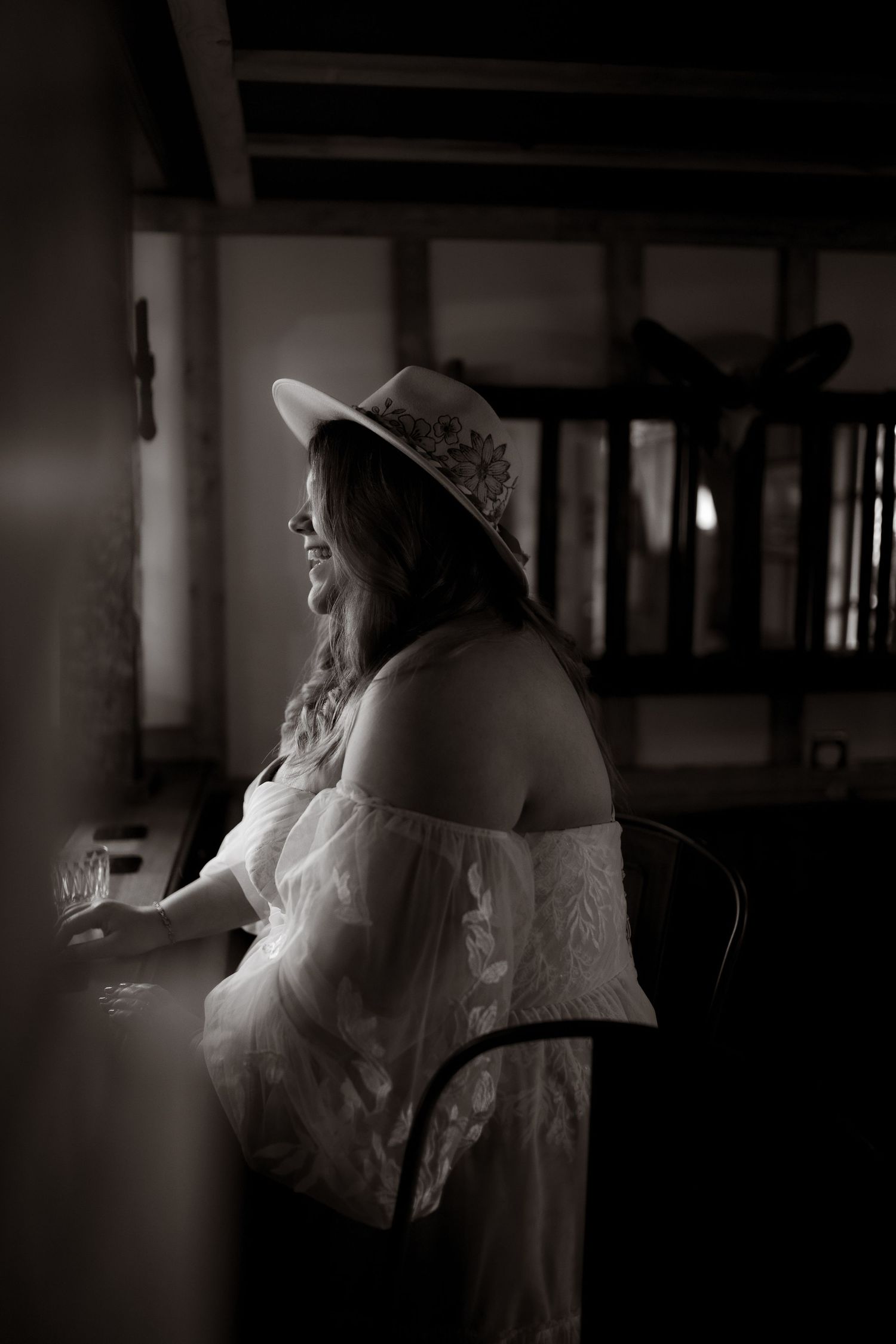 Dreamy black and white photo series in a shadowy indoor setting with elegant white dress.