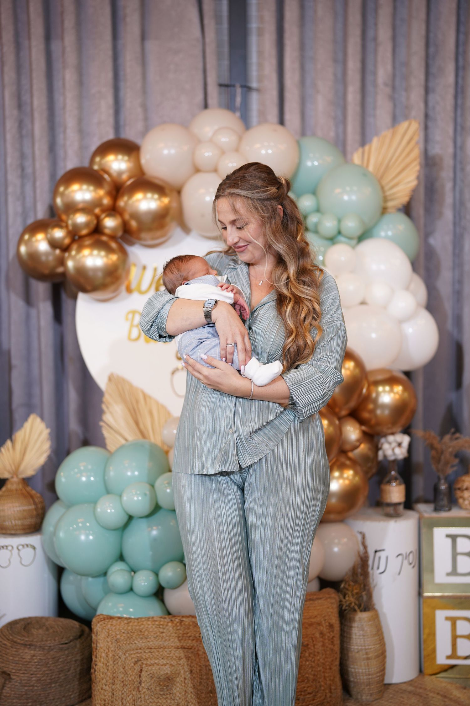 Emotional moment captured at a baby shower with elegant balloon decorations.