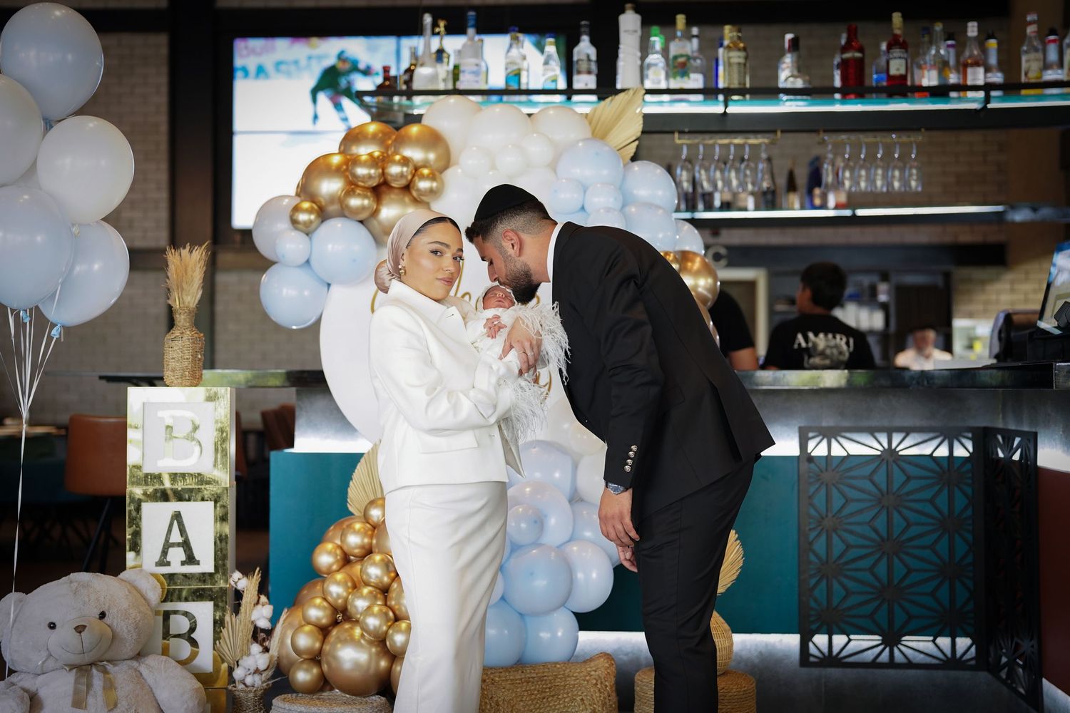 Elegant wedding reception setup with balloon decorations and bar area.