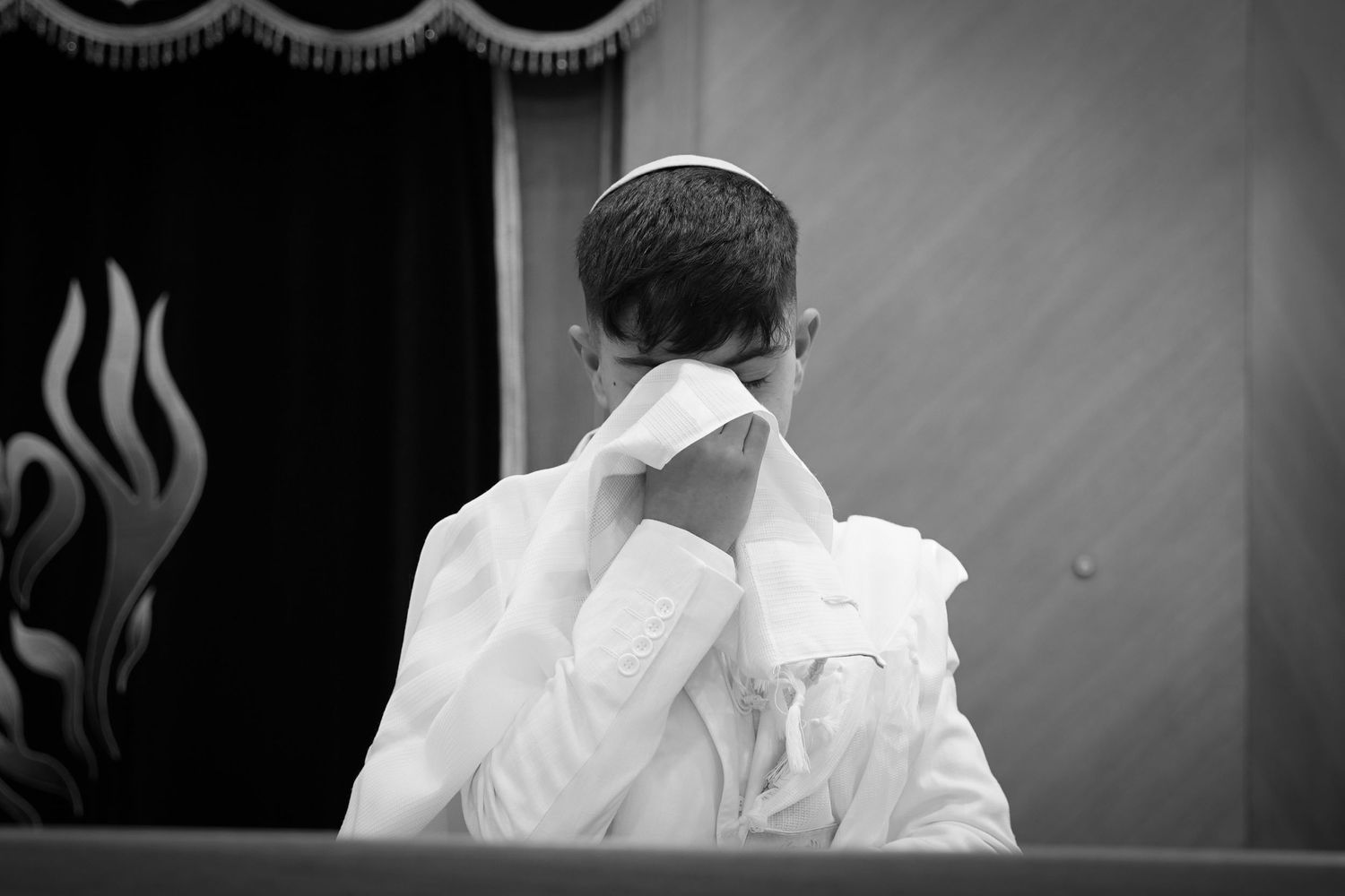 Black and white photograph of elegant wedding decorations and formal attire details.