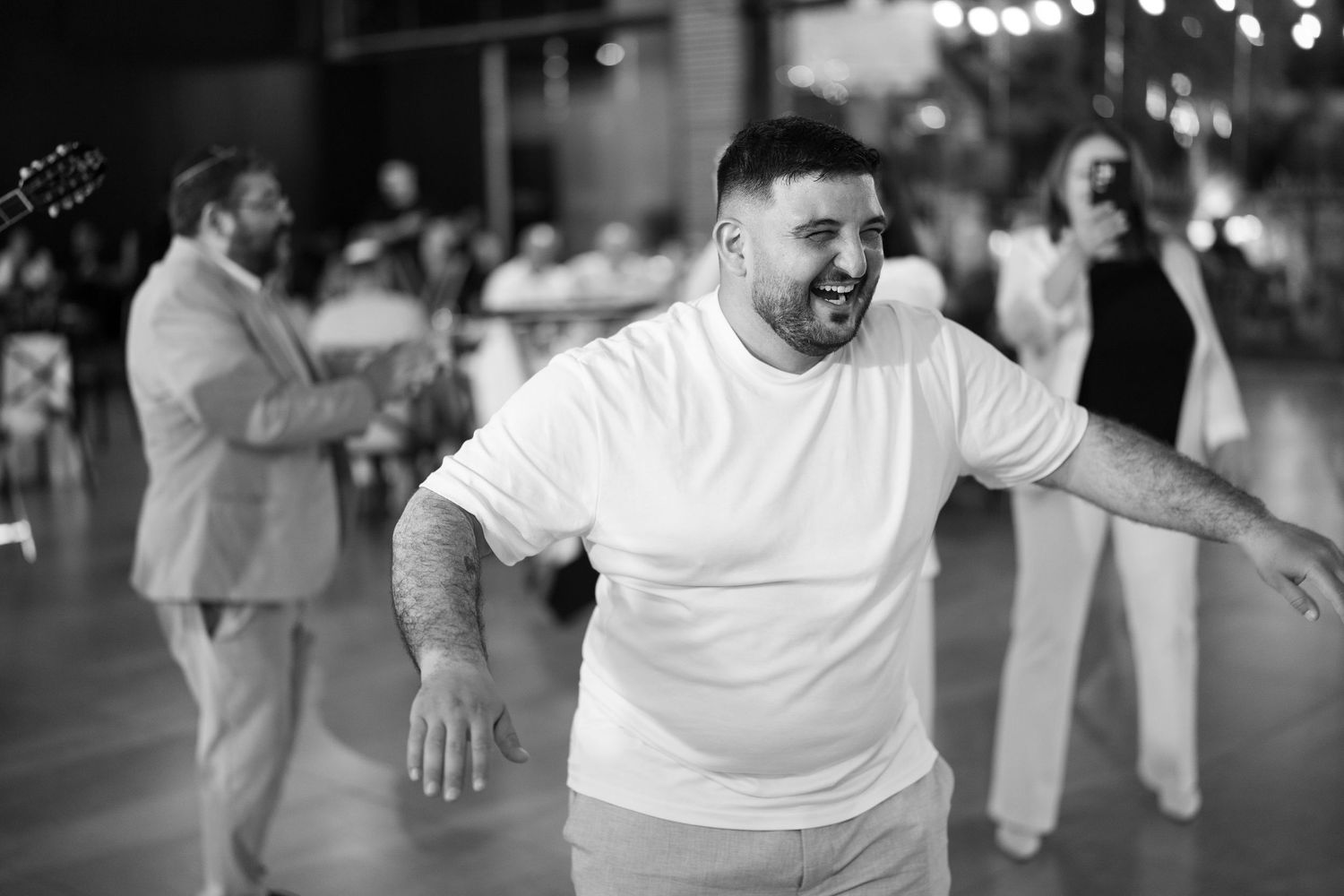 A series of black and white photos showing playful dancing moments at a celebration.