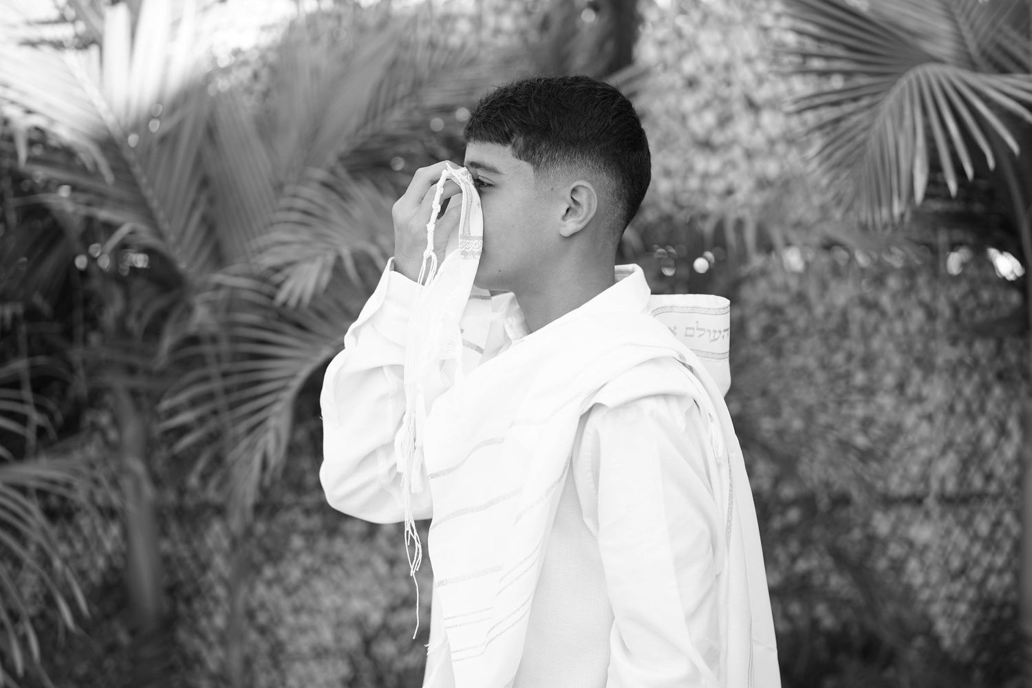 Series of candid black and white shots showing people in white clothing outdoors.