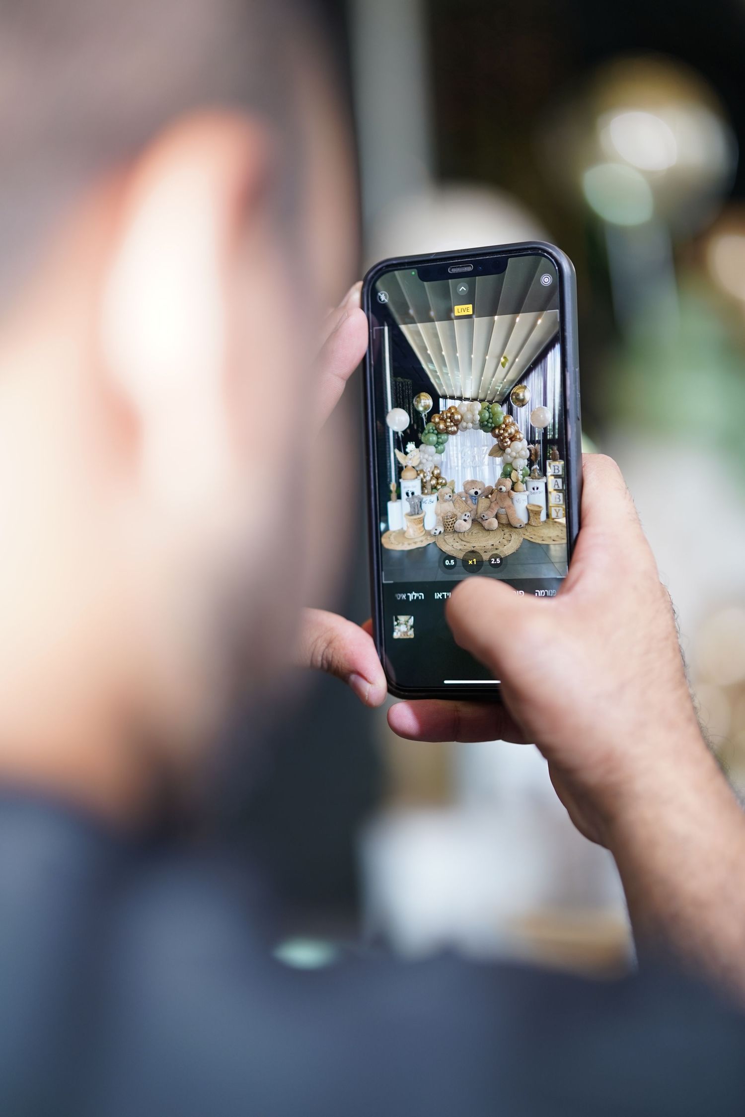 Person taking photos with a smartphone at an event.