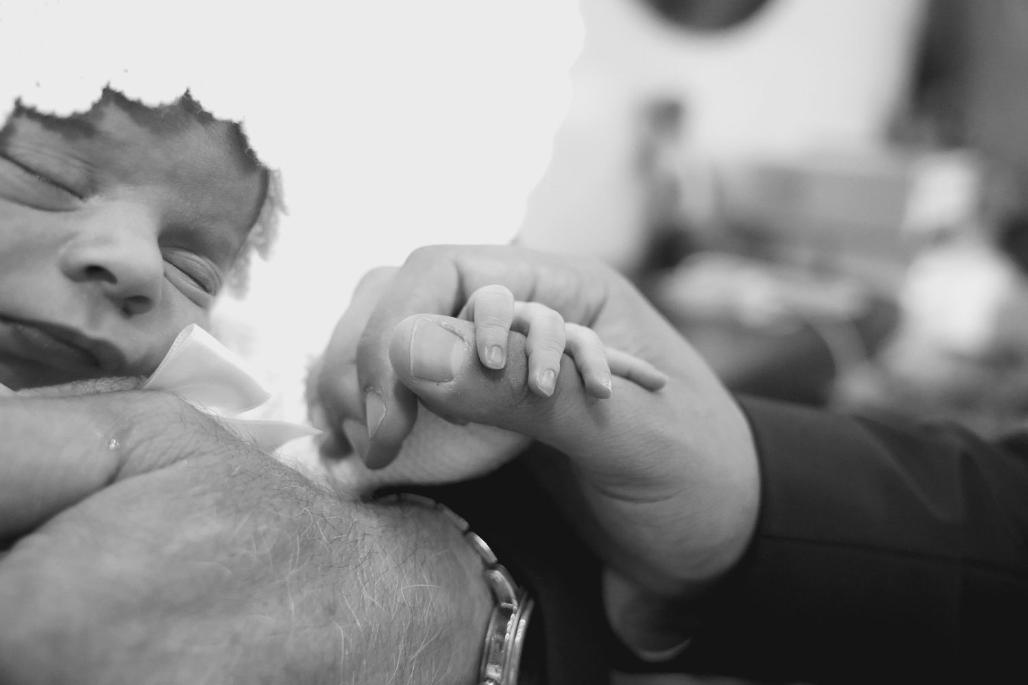 Close-up shot of hands exchanging rings during intimate moment.