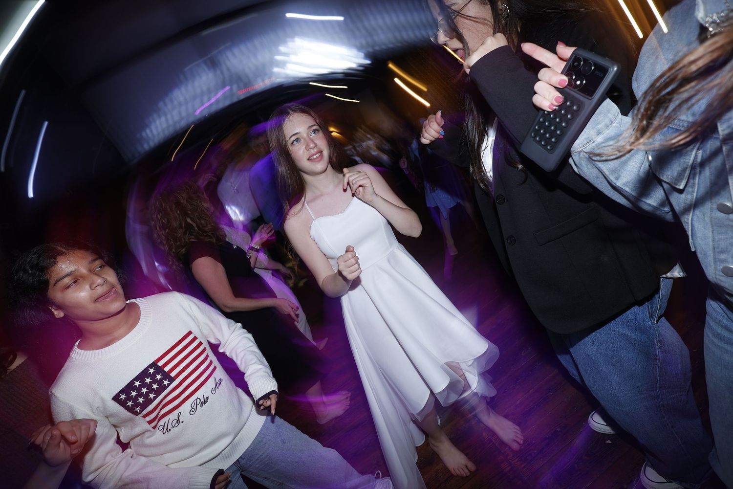 Nightclub atmosphere with blue lighting and crowd in motion.