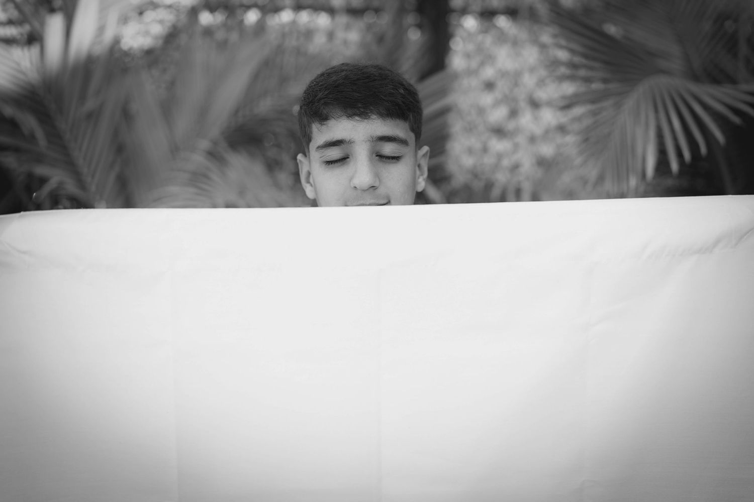 Portrait session in garden setting with natural greenery backdrop.