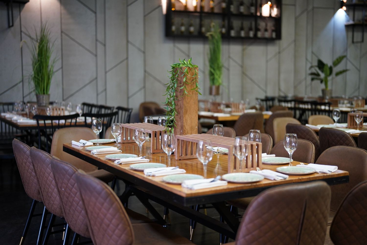 Upscale restaurant interior with plush seating and modern geometric wall designs.