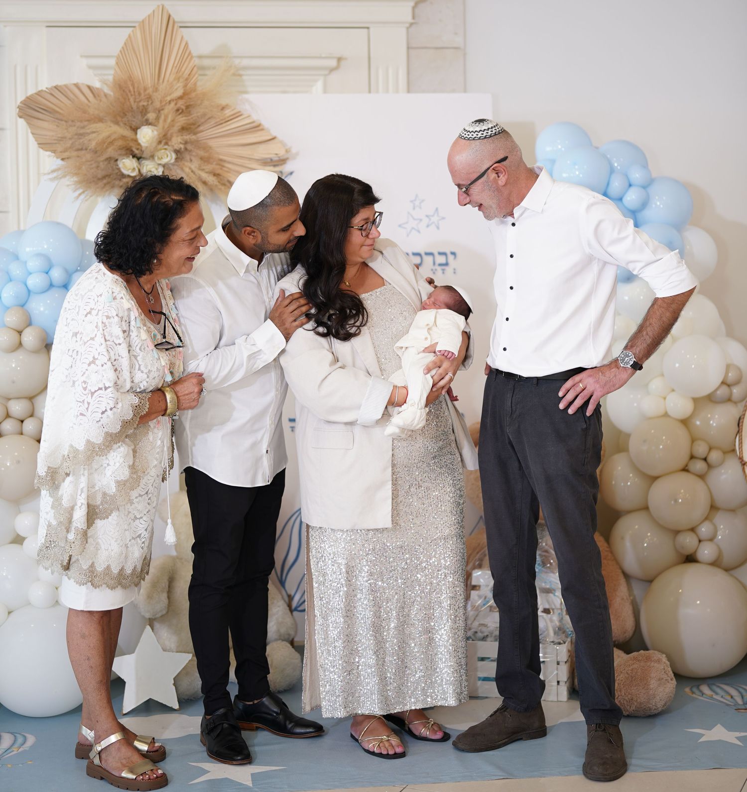 Extended family gathering with balloon decorations and formal attire.