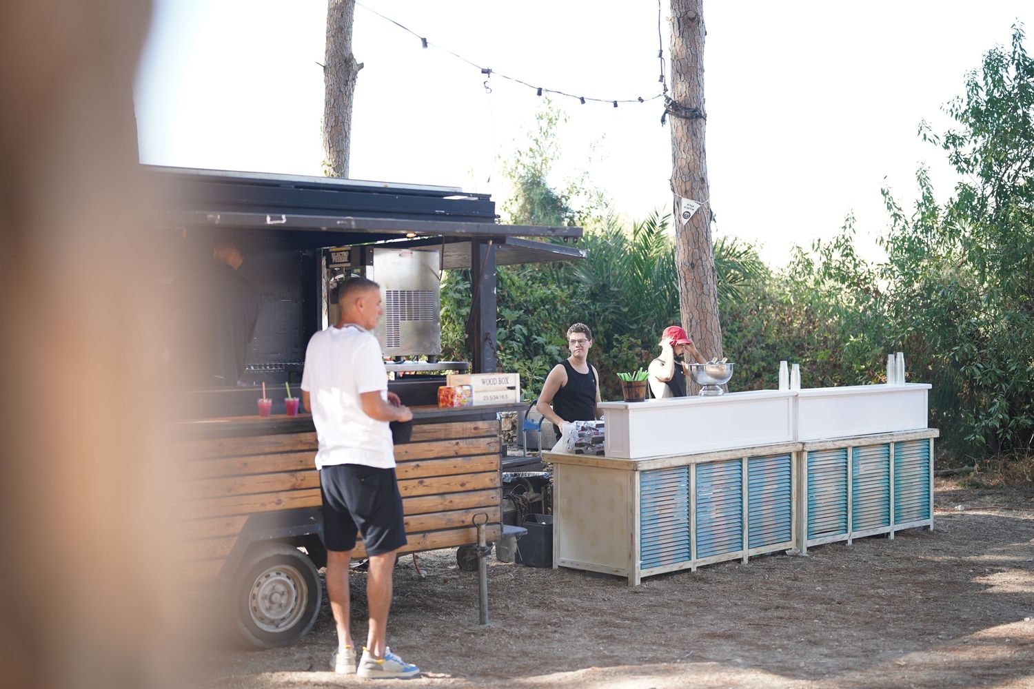 Outdoor event space with modern portable furniture and equipment setup.