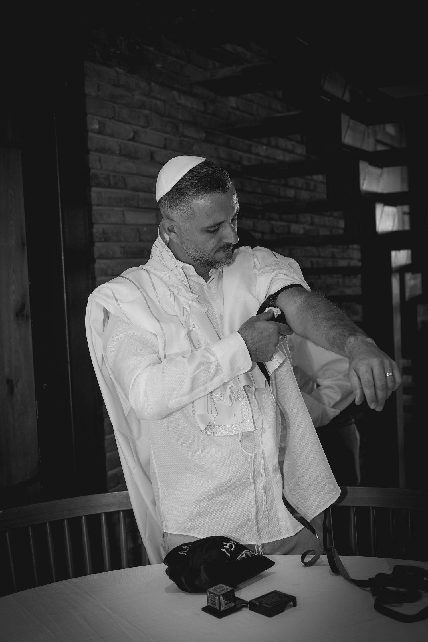 Black and white photo series showing emotional moments during a wedding speech at a reception.