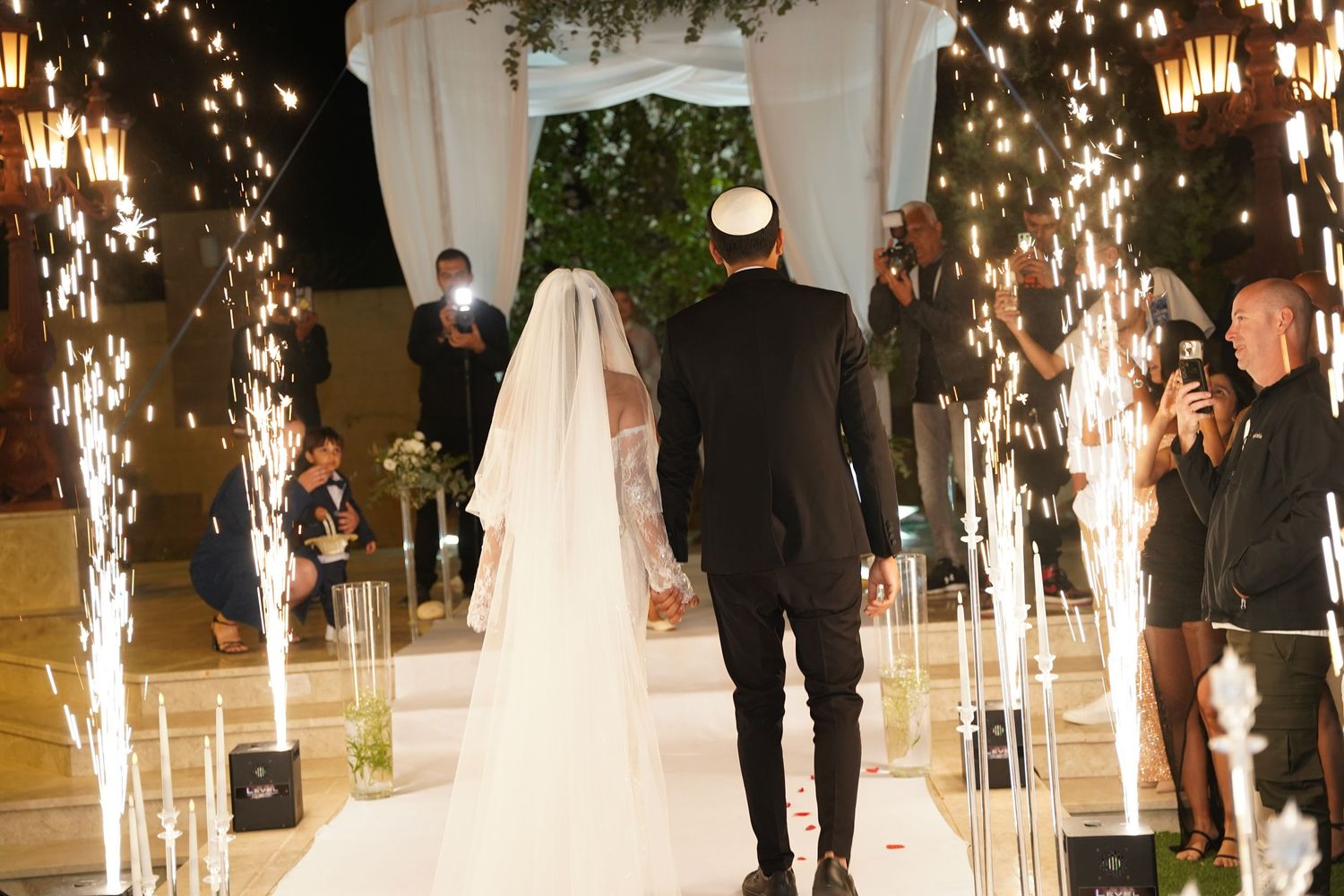 Wedding ceremony setup with sparklers creating a magical atmosphere in an elegant venue.