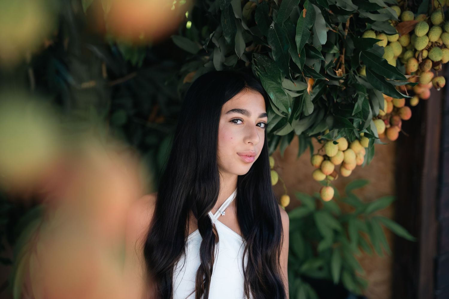 Artistic garden photoshoot with bokeh effect and natural elements.