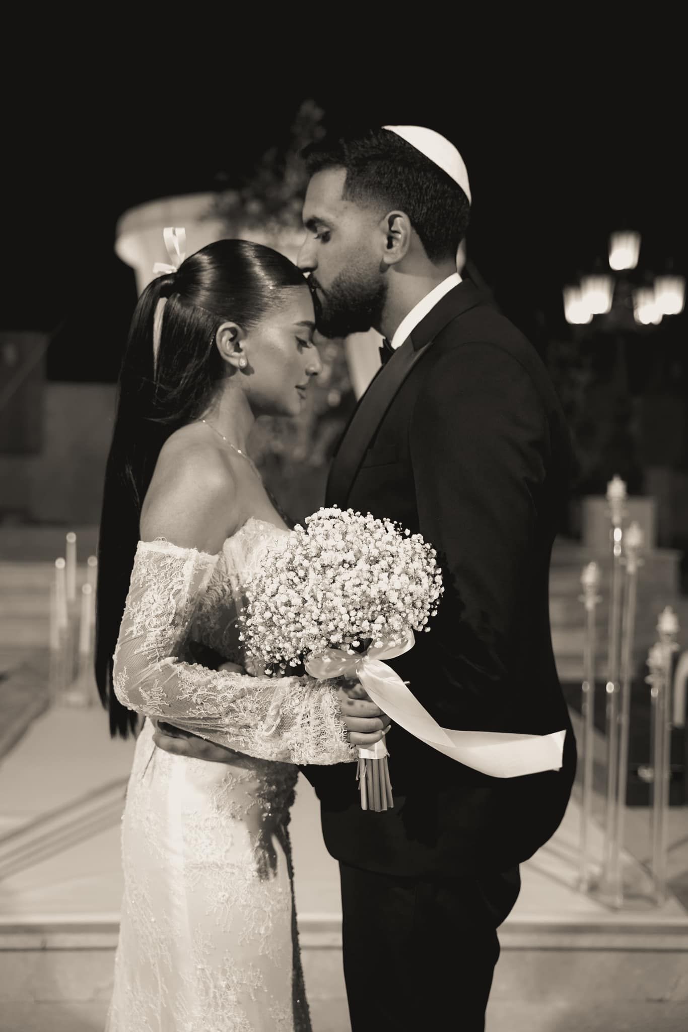Black and white wedding portraits showing tender moments between bride and groom.
