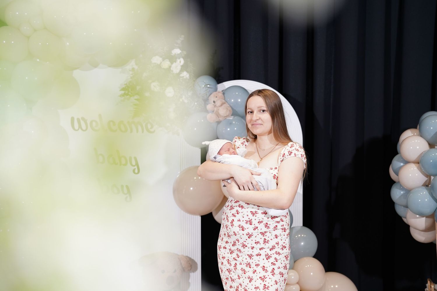 Gender reveal party setup with soft pastel balloons and decorative elements.