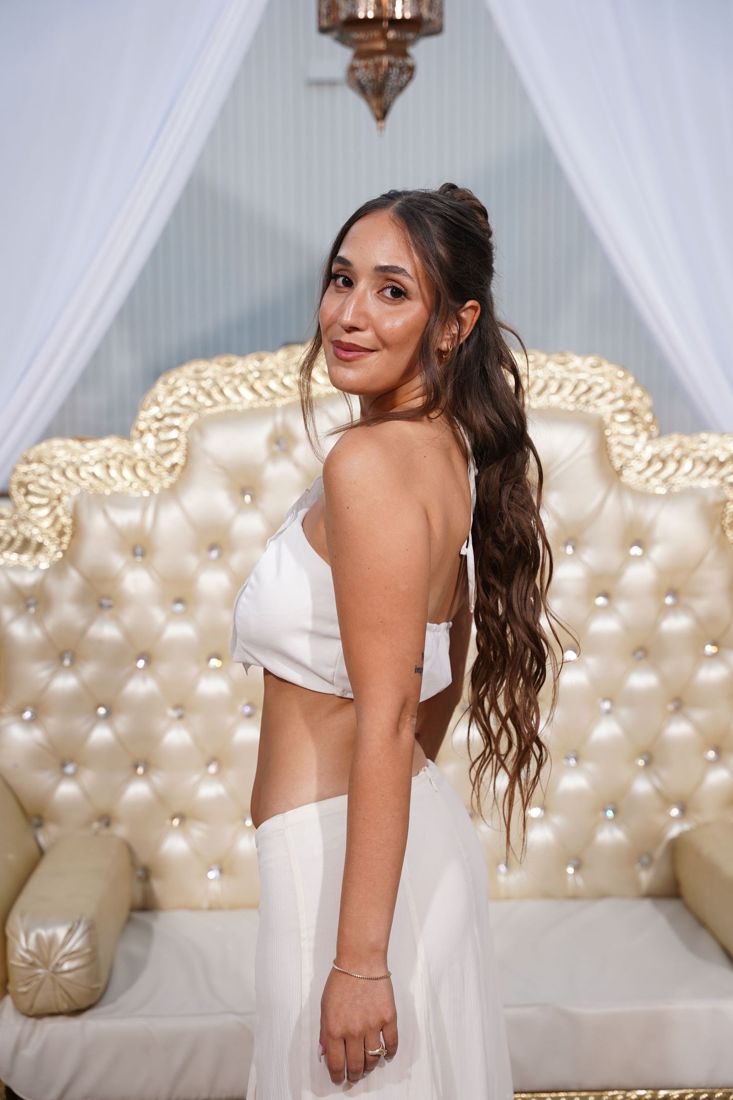 Stylish portrait series against an elegant cream and gold tufted sofa backdrop.