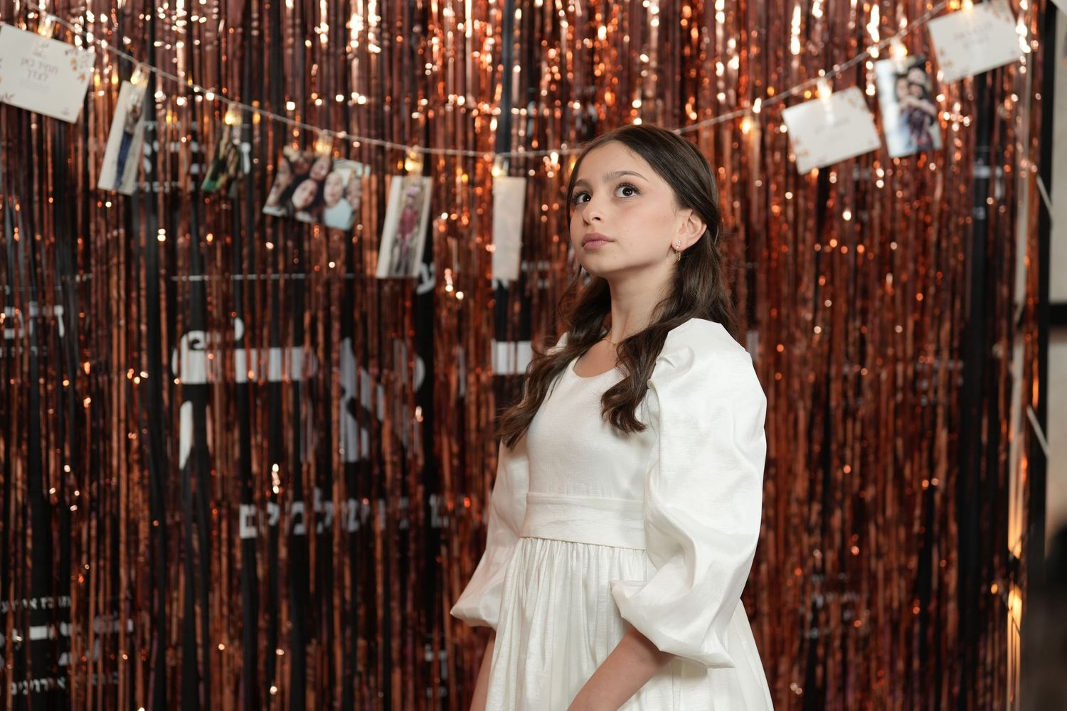 Four sequential photos show someone in a white dress posing against a sparkly copper-colored curtain backdrop.