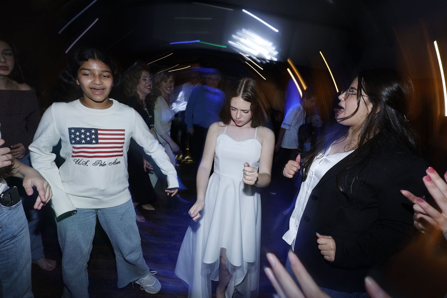 Dark party scene with neon lighting and dancing silhouettes.
