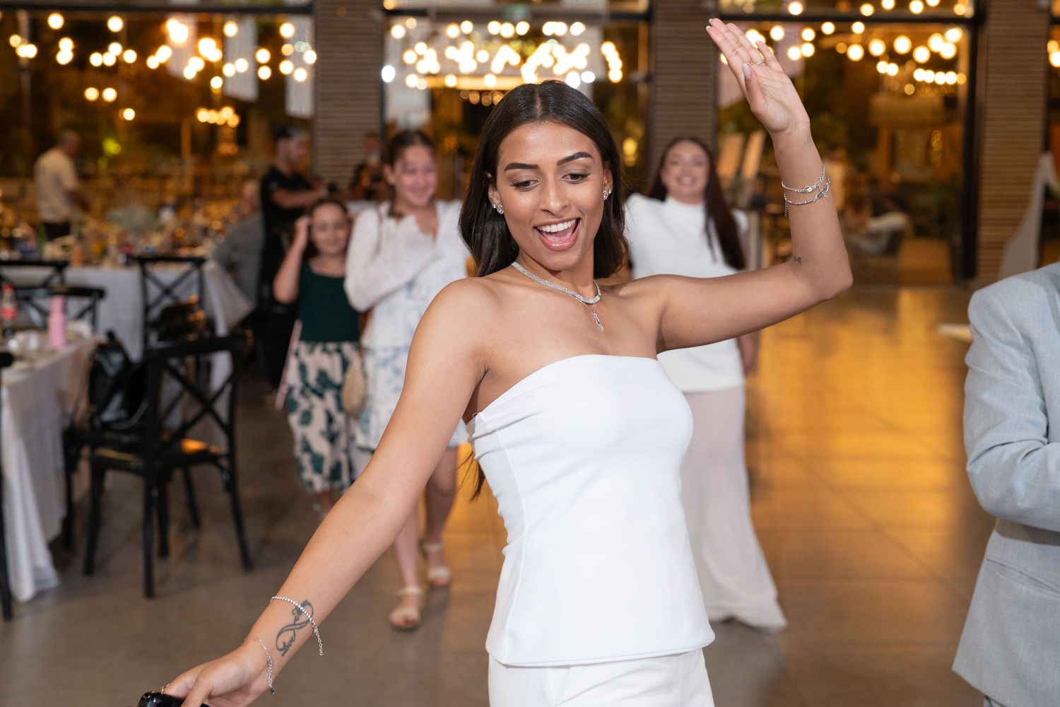 Celebration in an event venue with warm lighting and festive atmosphere.