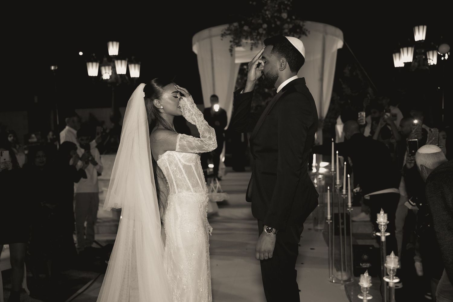 Black and white photo series capturing intimate moments between newlyweds during their ceremony.