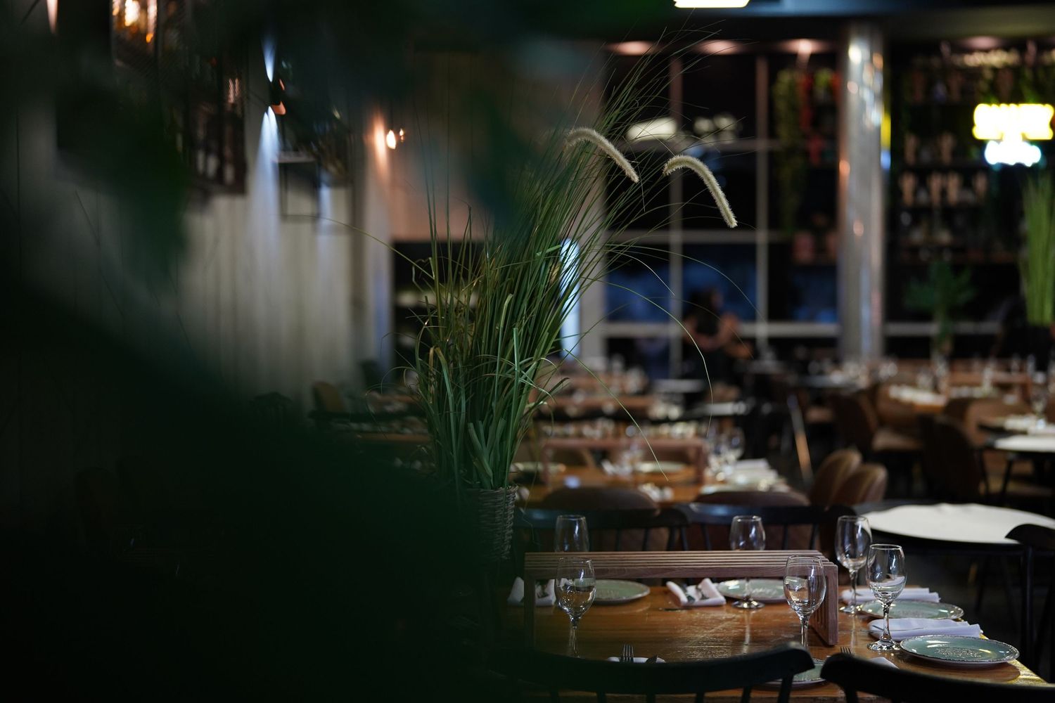 Dark and moody interior of an upscale restaurant with ambient lighting.