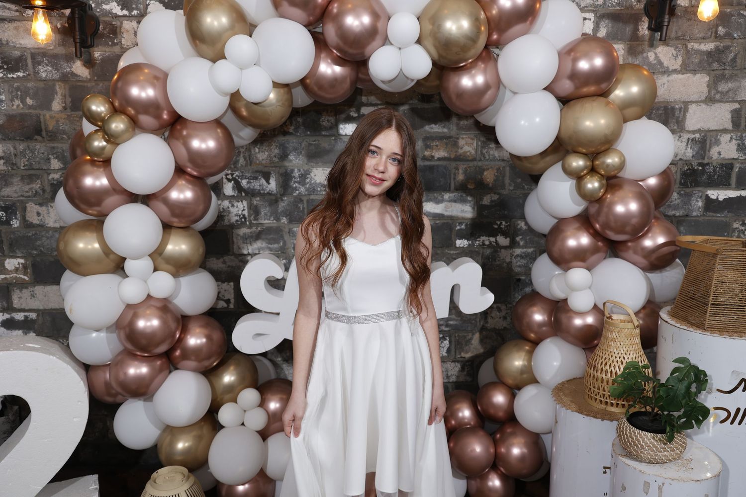 Celebration scene with luxurious balloon garland in white, rose gold and champagne colors.