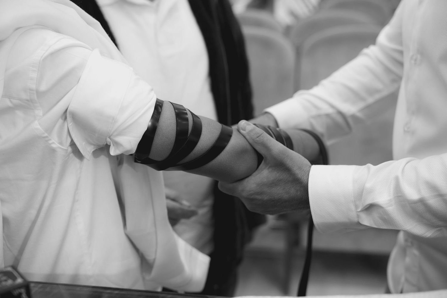Close-up of hands during traditional religious ceremony ritual.