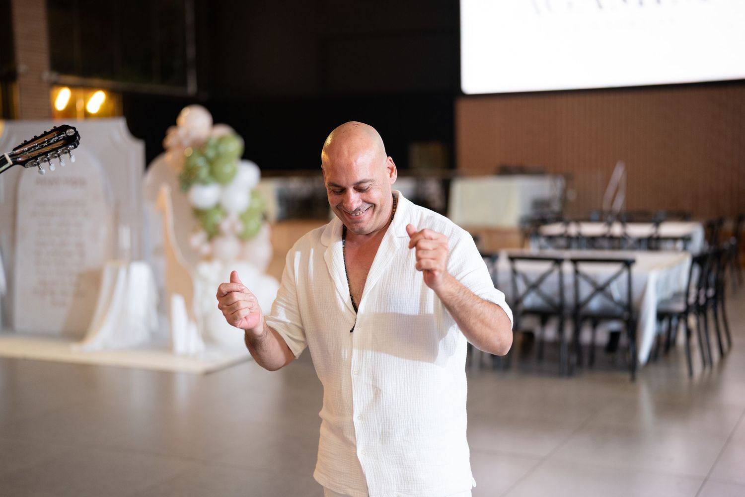 Evening celebration at an indoor venue with ambient lighting and dancing.