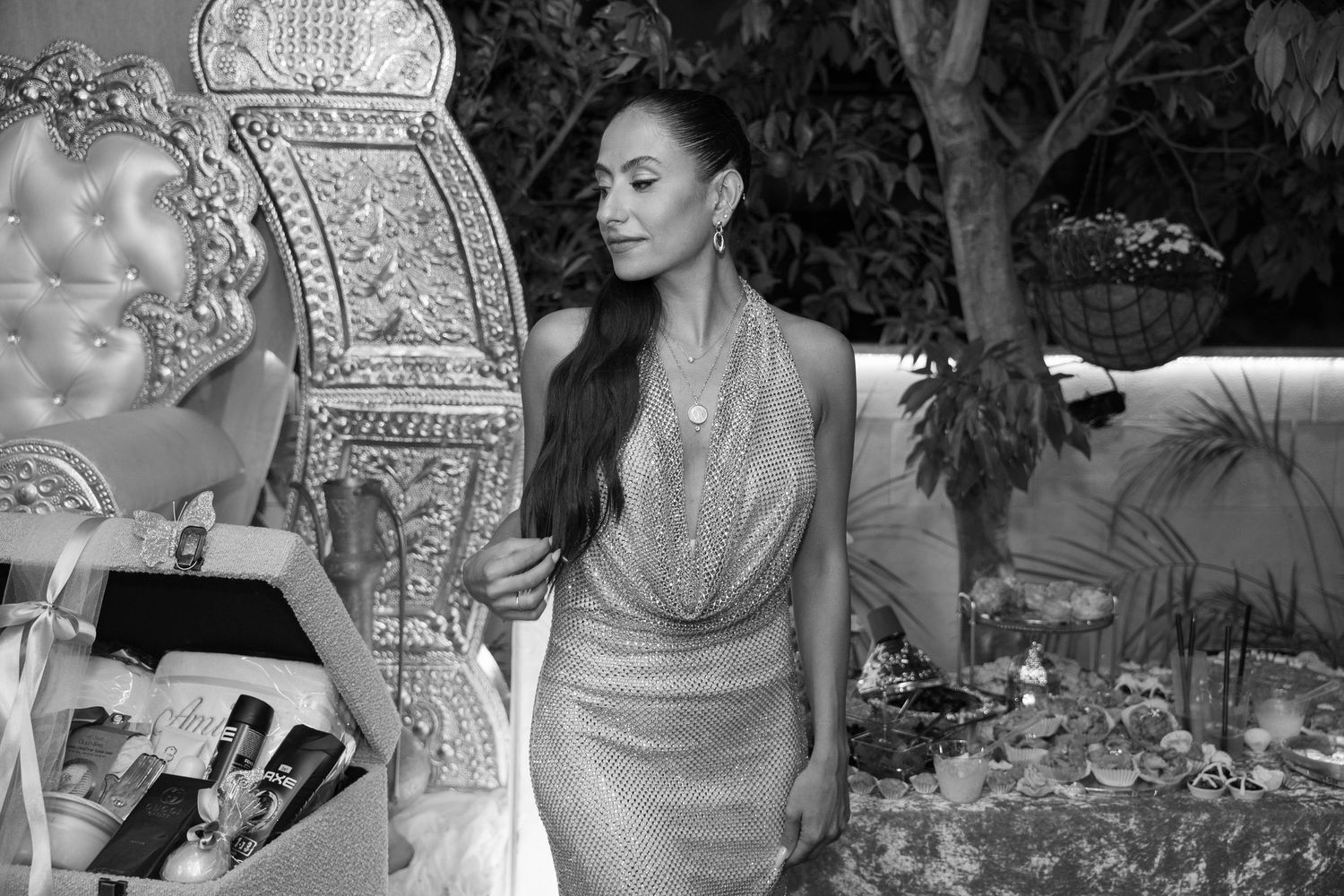 Black and white candid shots of wedding guests celebrating in an elegant venue setting.