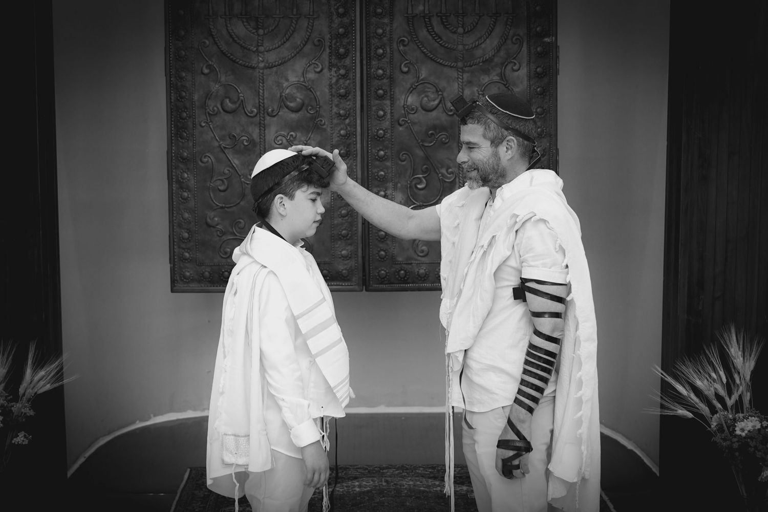 Black and white photo of people interacting during a religious ceremony.