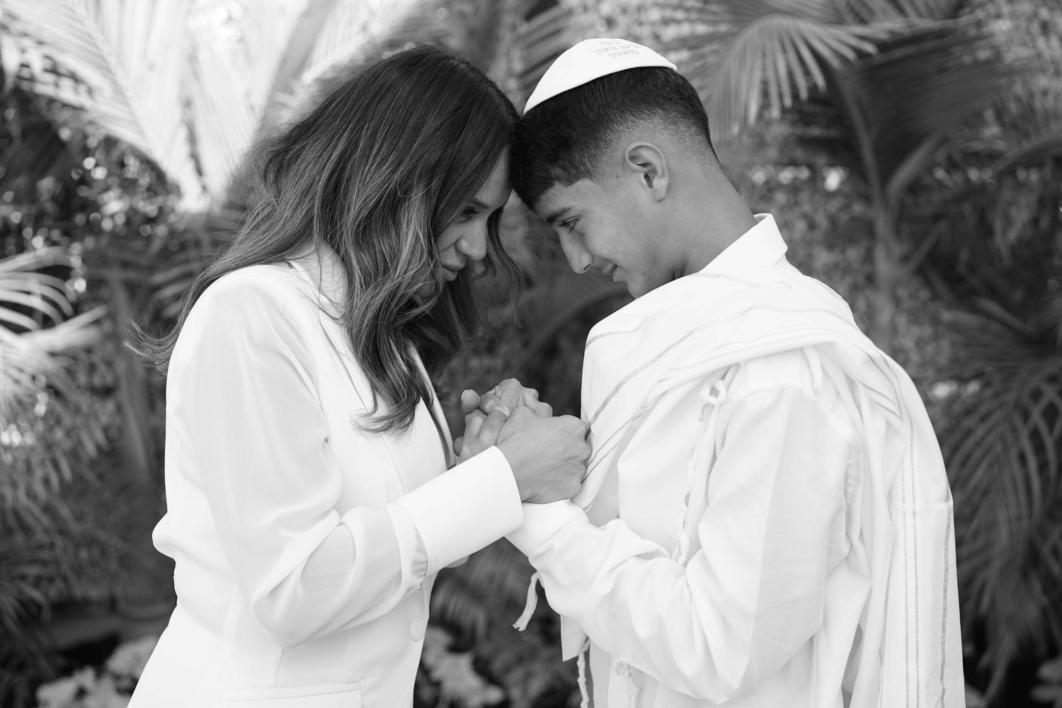 Black and white portraits of people in white formal attire against garden backdrop.